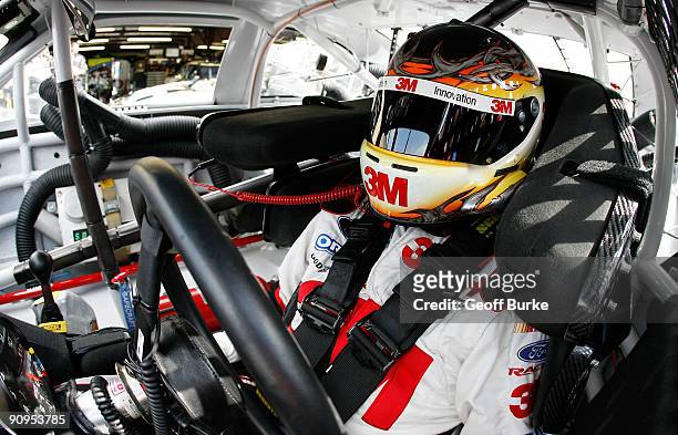 Greg Biffle, driver of the 3M/Scotch Ford, sits in his car prior to practice for the NASCAR Sprint Cup Series Sylvania 300 at the New Hampshire Motor...