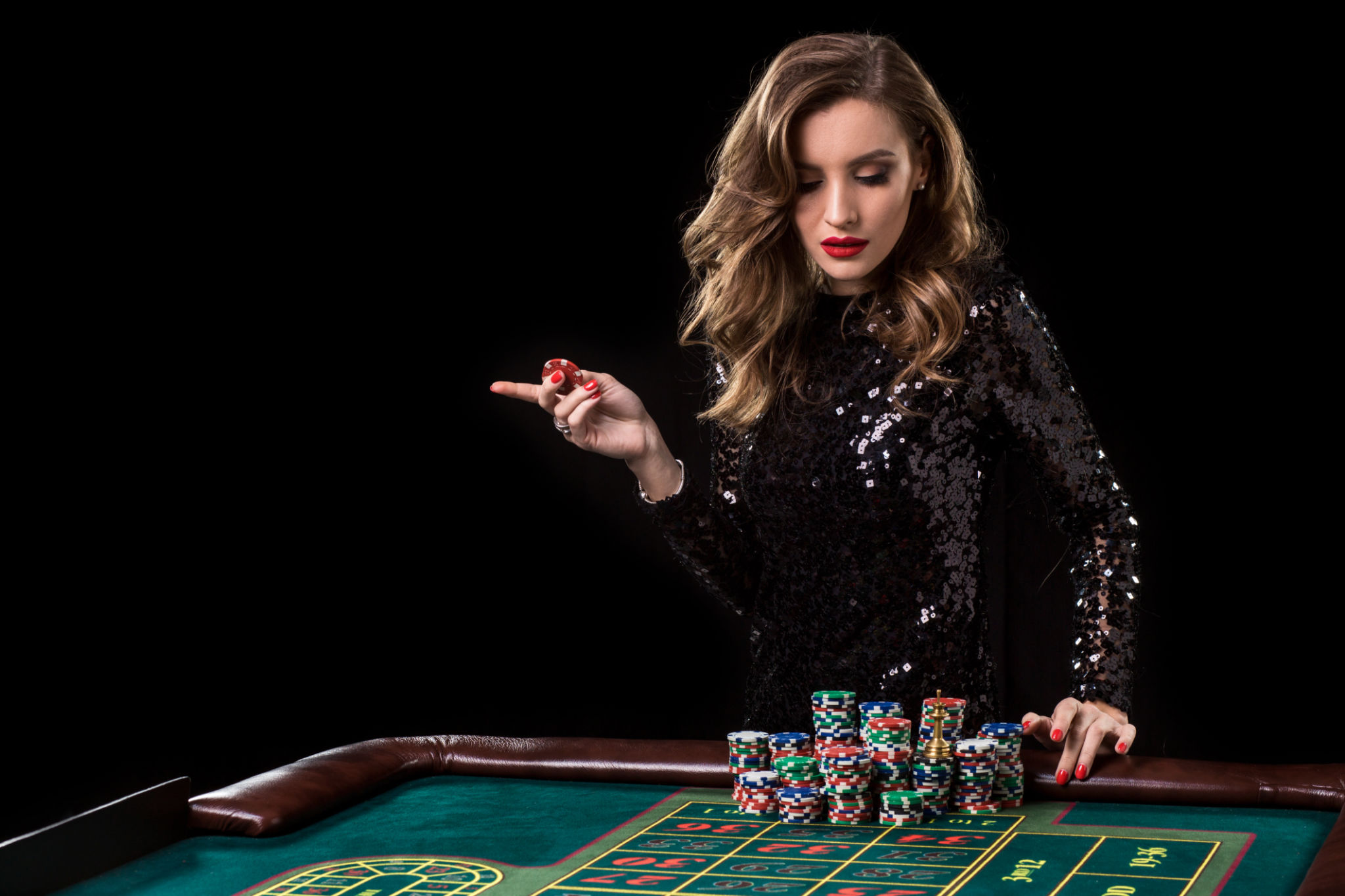 Woman playing in casino. Woman stakes piles of chips playing rou Woman playing in casino. Woman stakes piles of chips playing rou