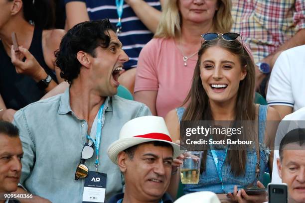 Radio personality Andy Lee and his partner Rebecca Harding watch the quarter-final between Roger Federer of Switzerland and Tomas Berdych of the...