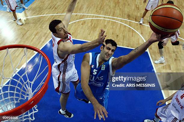 Turkey's Hidayet Türkoglu tries to block a shot by Ioannis Bourousis of Greece during their 2009 European Championship Basketball quarter-final game...