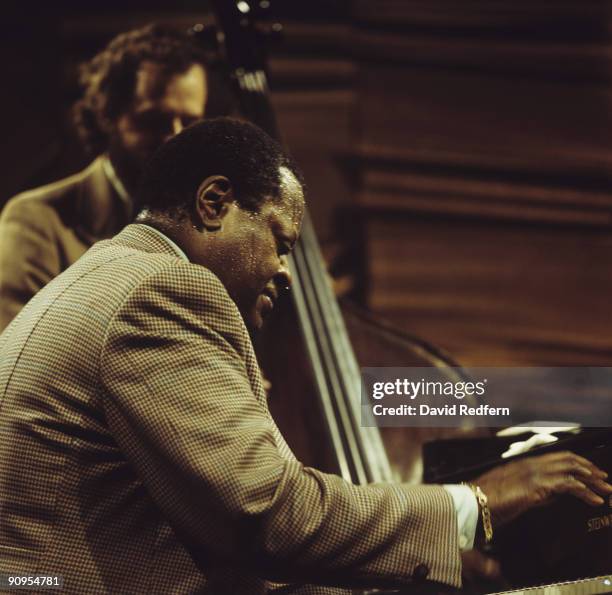 Pianist Oscar Peterson performs on stage at Ronnie Scott's in London, England in 1974.