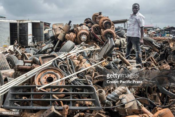 Man sorting the recyclable junk. In the outskirts of Accra there is the biggest electronic waste disposal site, also called by the locals with...