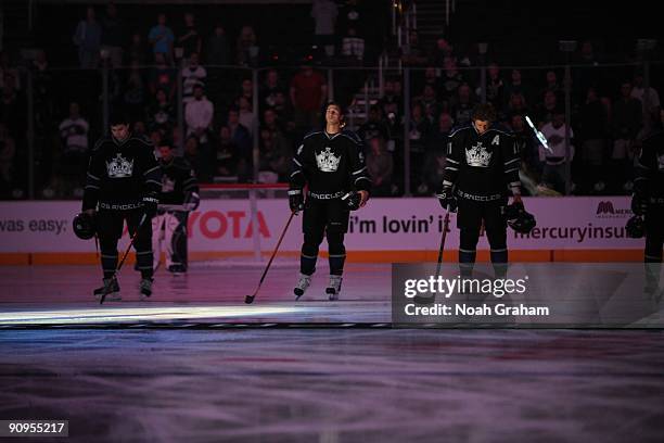 Drew Doughty, Ryan Smyth, and Anze Kopitar of the Los Angeles Kings stand on the ice before the game against the Phoenix Coyotes on September 15,...