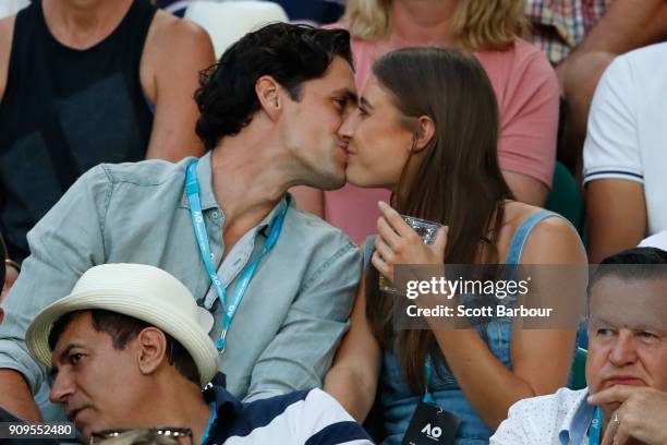 Radio personality Andy Lee and his partner Rebecca Harding watch the quarter-final between Roger Federer of Switzerland and Tomas Berdych of the...