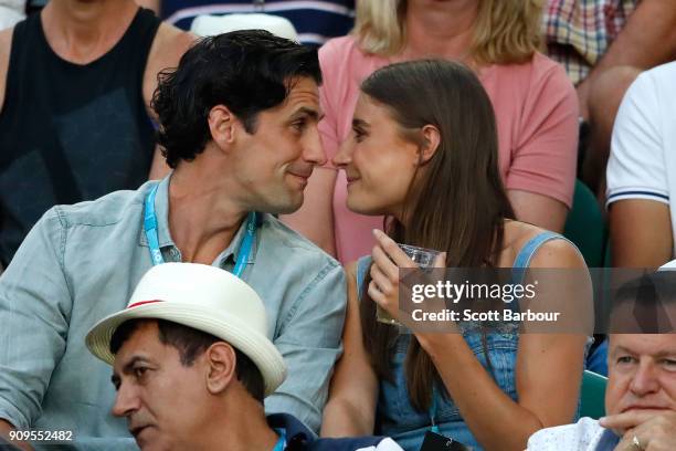 Radio personality Andy Lee and his partner Rebecca Harding watch the quarter-final between Roger Federer of Switzerland and Tomas Berdych of the...