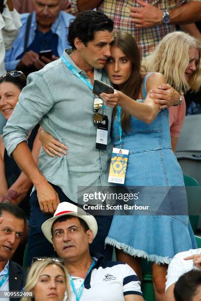 Radio personality Andy Lee and his partner Rebecca Harding watch the quarter-final between Roger Federer of Switzerland and Tomas Berdych of the...