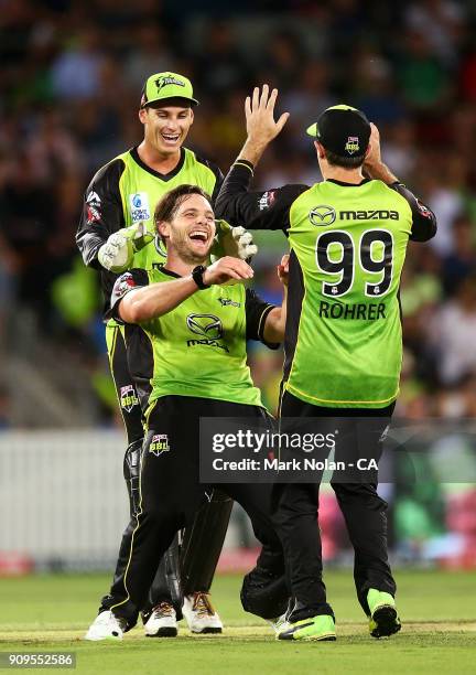 Mitchell McClenaghan of the Thunder celebrates getting the wicket of Dwayne Bravo of the Renegades during the Big Bash League match between the...