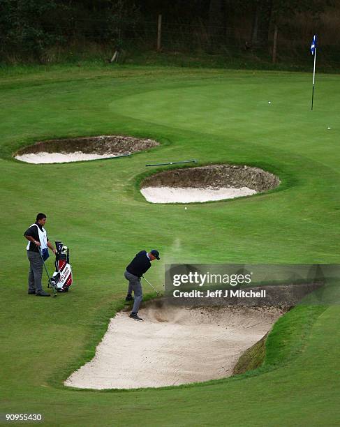 Mark Sheftic of the USA plays out the bunker on the 13th green in the afternoon four ball matches at The Carrick on Loch Lomond on September 18, 2009...