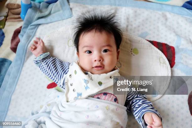 smiling baby lying on blanket - よだれ掛け ストックフォトと画像