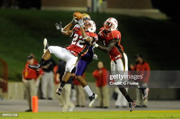 Cameron Chism and Terrell Skinner of the Maryland Terrapins break up a pass during the game against the James Madison Dukes at Byrd Stadium on...