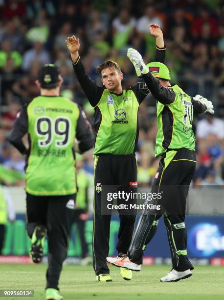 Chris Green of the Thunder celebrates with team mates after taking the wicket of Marcus Harris of the Renegades during the Big Bash League match...