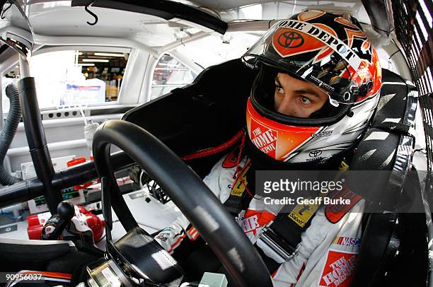 Joey Logano, driver of the Home Depot Toyota, sits in his car prior to practice for the NASCAR Sprint Cup Series Sylvania 300 at the New Hampshire...