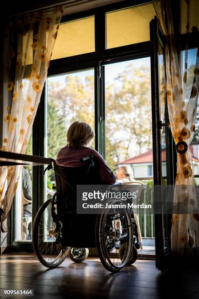 Old woman in wheelchair indoors