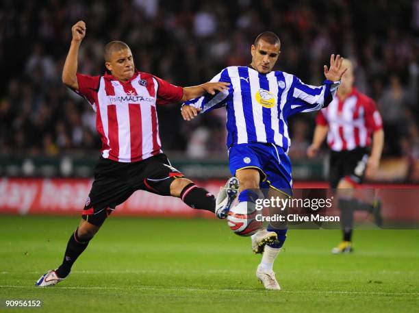 Marcus Tudgay of Sheffield Wednesday is challenged by Kyle Walker of Sheffield United during the Coca-Cola Championship match between Sheffield...