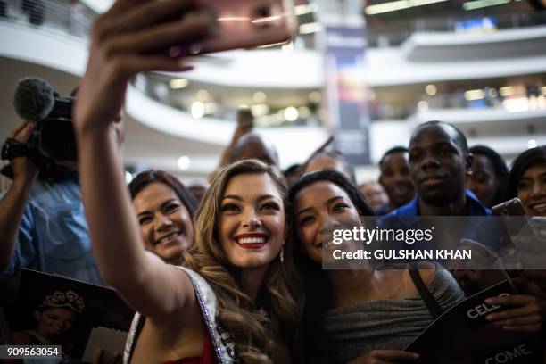 Miss Universe 2017 Demi-Leigh Nel-Peters poses for a 'selfie' with fans as she arrives home to South Africa for the first time after being crowned at...