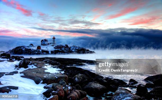 nubble lighthouse in arctic sea smoke - york maine stock pictures, royalty-free photos & images