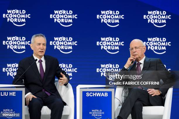 Member of the Political Bureau of the Communist Party of China Central Committee Liu He gestures next to Founder and Executive Chairman of the World...