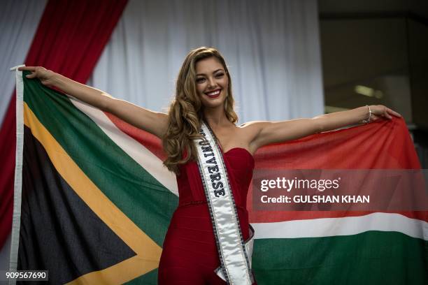 Miss Universe 2017 Demi-Leigh Nel-Peters poses with a South African flag at OR Tambo International Airport in Johannesburg, after arriving home to...