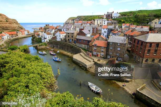 an elevated view of the fishing village of staithes, north yorkshire, england - north yorkshire stock pictures, royalty-free photos & images