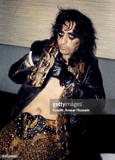 Alice Cooper poses backstage with a snake following a performance at the Empire Pool Wembley on June 30, 1972 in London, England.
