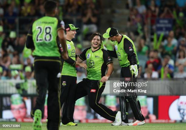 Mitchell McClenaghan of the Thunder celebrates with team mates after taking the wicket of Dwayne Bravo of the Renegades during the Big Bash League...
