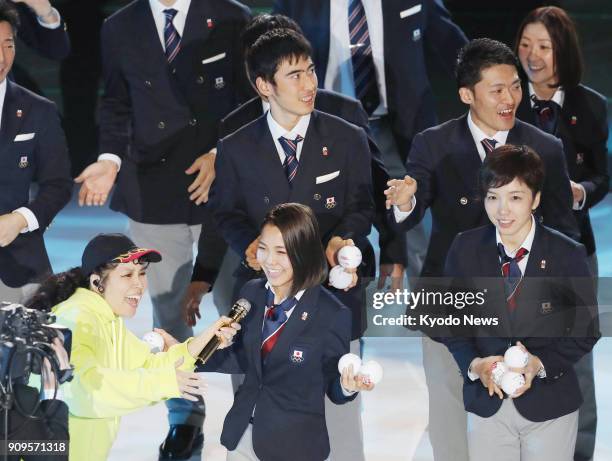 Japanese pop singer AI and ski jumper Sara Takanashi sing together during a send-off ceremony in Tokyo on Jan. 24 ahead of the start of the...