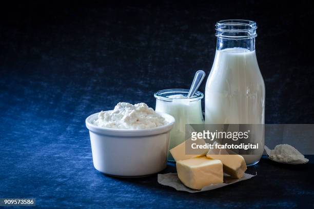 dairy products shot on bluish tint background - food photography dark background blue imagens e fotografias de stock