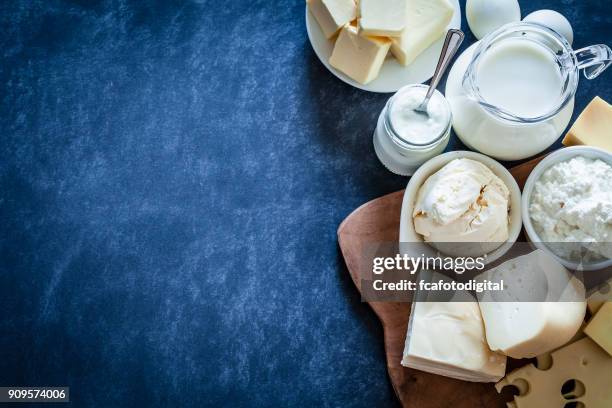 dairy products shot on bluish tint background - milk products top view stock pictures, royalty-free photos & images