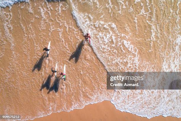 surfers going into the sea - surfer by the beach australia stock pictures, royalty-free photos & images