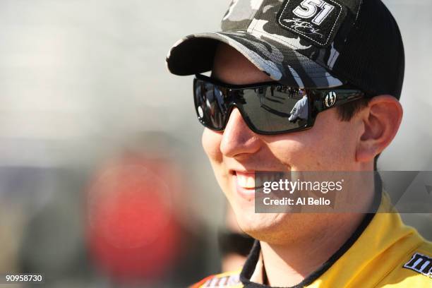 Kyle Busch, driver of Dupont / National M&M's Toyota looks on during qualifying for the NASCAR Sprint Cup Series Sylvania 300 at the New Hampshire...