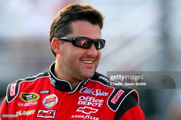 Tony Stewart, driver of the Old Spice/Office Depot Chevrolet stands on the grid during qualifying for the NASCAR Sprint Cup Series Sylvania 300 at...