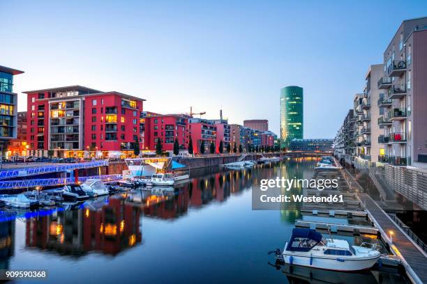 germany, frankfurt, apartment buildings at westhafen with westhafen tower in the background - water main stock-fotos und bilder