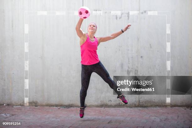 woman jumping to catch a ball - woman catching stock pictures, royalty-free photos & images