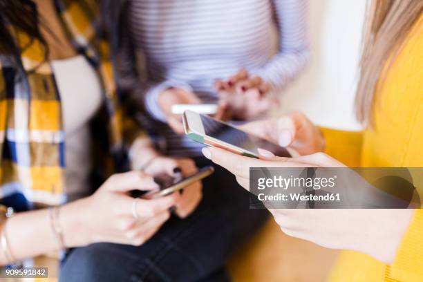 hands of three women using smartphones - all access events stockfoto's en -beelden