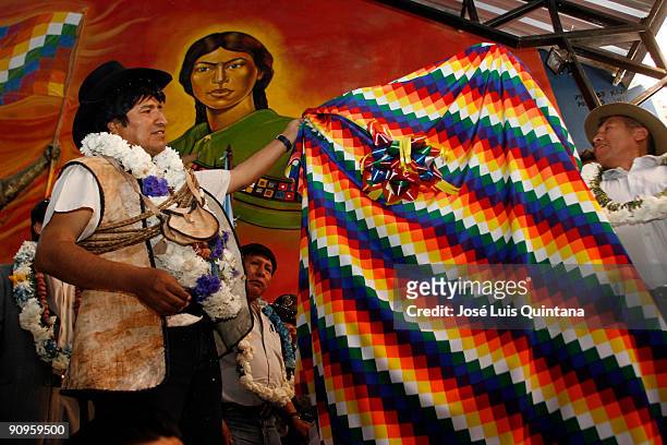 Bolivian President Evo Morales takes the wiphala off the commemorative plaque in honour of the new Bolivian Rural Workers Union's headquarters on...