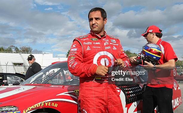 Juan Pablo Montoya , driver of the Target Chevrolet, stands near his car after his run during qualifying for the NASCAR Sprint Cup Series Sylvania...