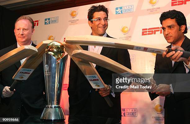 International Cricket Council General Manager, Commercial Campbell Jamieson , cricketers Sanjay Manjrekar and Wasim Akram pose with a replica of The...