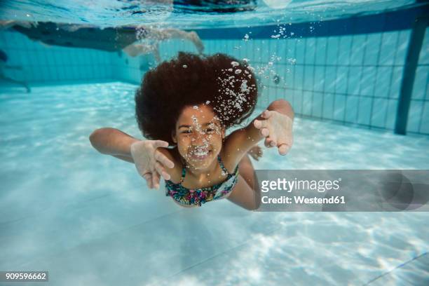 girl swimming under water in swimming pool - preteen swimwear bildbanksfoton och bilder