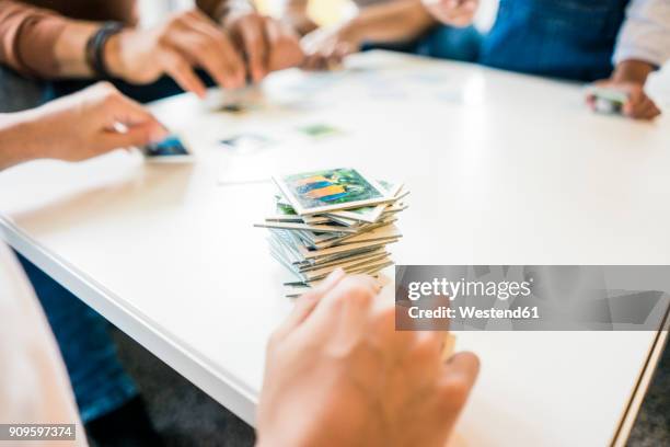 family sitting on couch , playing memory game - hand of cards stock-fotos und bilder