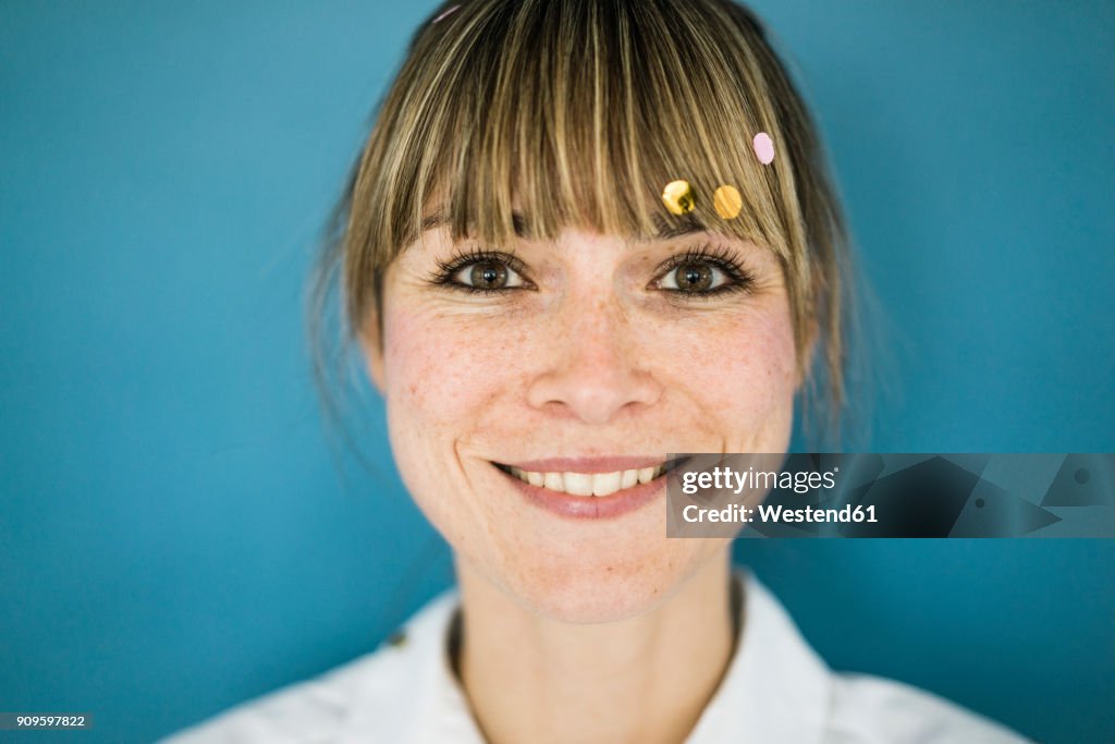 Portrait of smiling woman with confetti in her hair