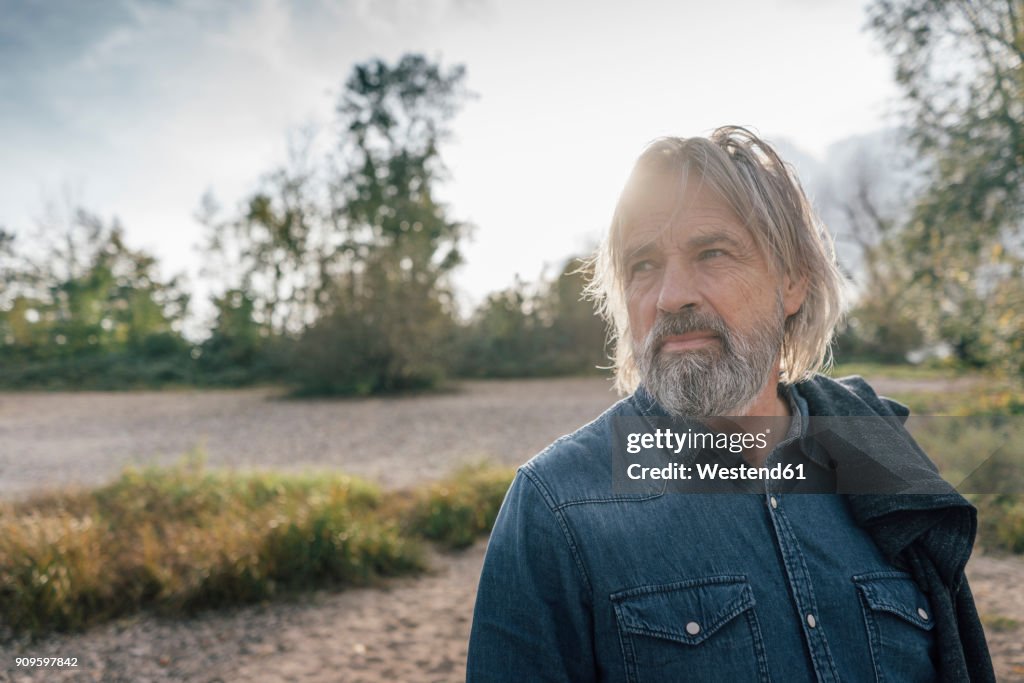 Attractive senior enjoying being outdoors, portrait