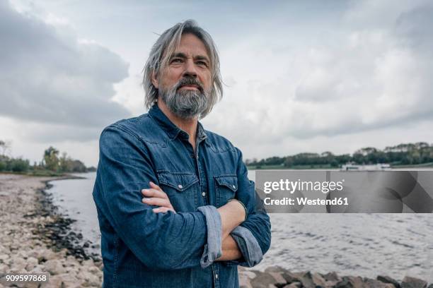 attractive senior enjoying being outdoors, portrait - pelo facial fotografías e imágenes de stock