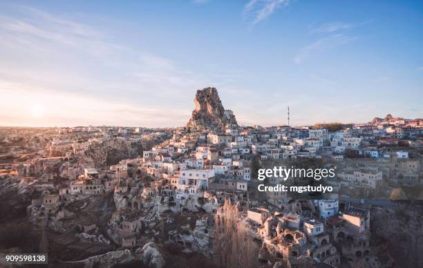 ortahisar cave city in cappadocia, turkey on sunset - ortahisar stock pictures, royalty-free photos & images