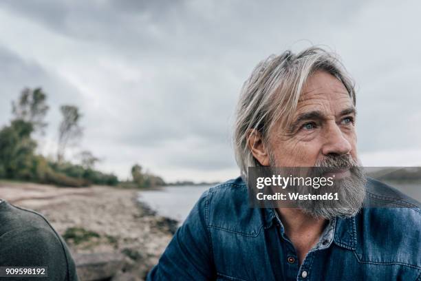 attractive senior enjoying being outdoors, portrait - 60's stock-fotos und bilder