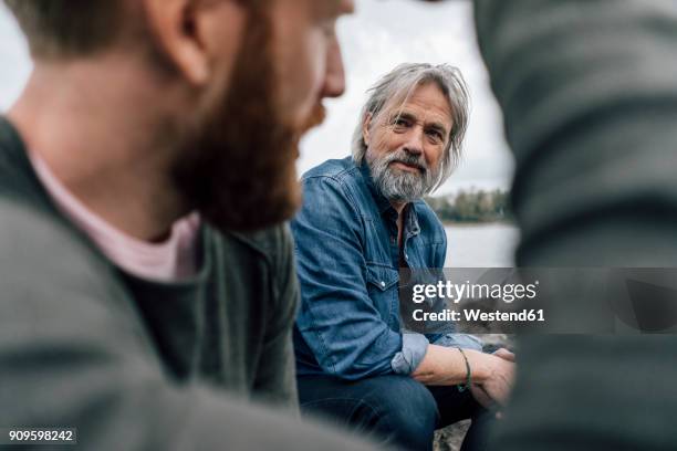 father and son meeting at rhine river in autmn, talking together - father son admiration stock pictures, royalty-free photos & images