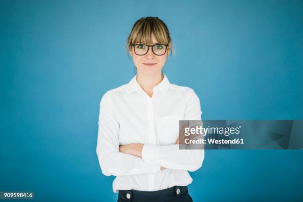 portrait of smiling businesswoman with glasses - waist up imagens e fotografias de stock