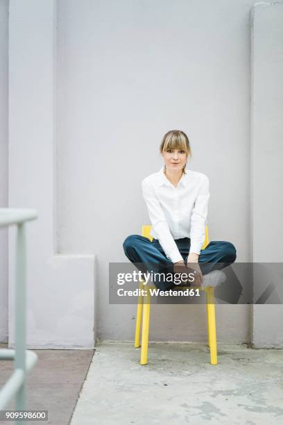 portrait of woman sitting on a chair - white blouse bildbanksfoton och bilder