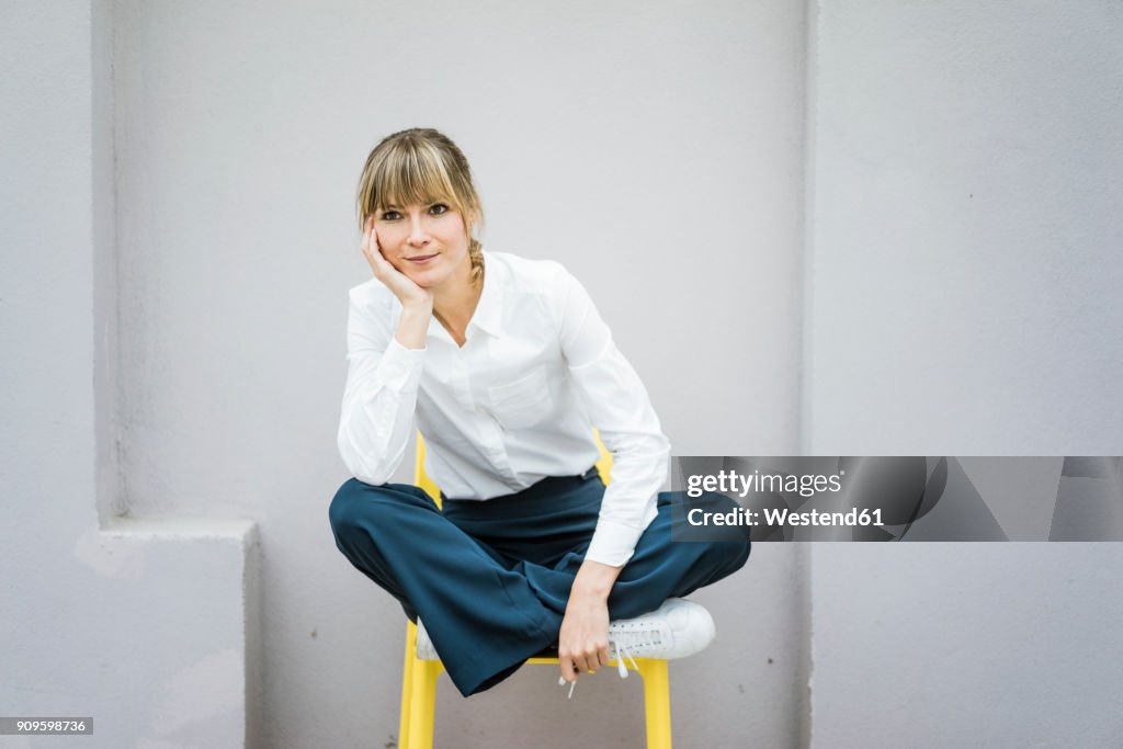 Portrait of woman sitting on a chair