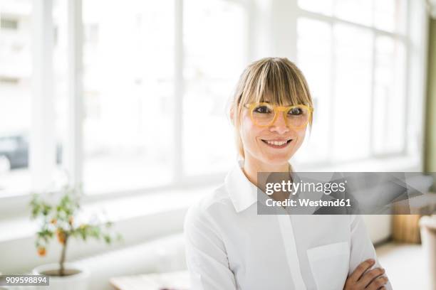 portrait of smiling woman wearing glasses - white blouse fotografías e imágenes de stock