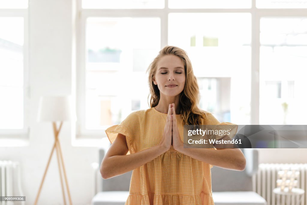 Young woman wearing a dress practising yoga
